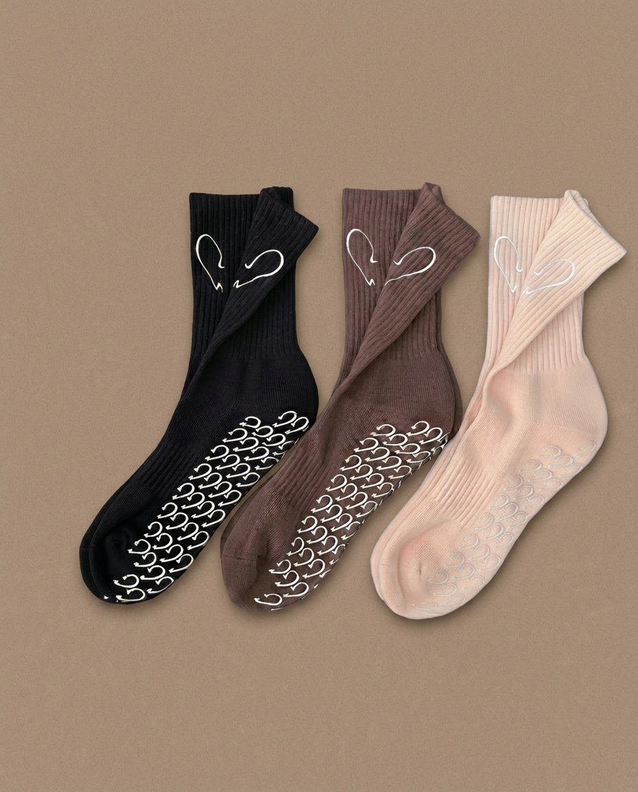 A pair of cream ribbed cotton socks with a small embroidered heart
